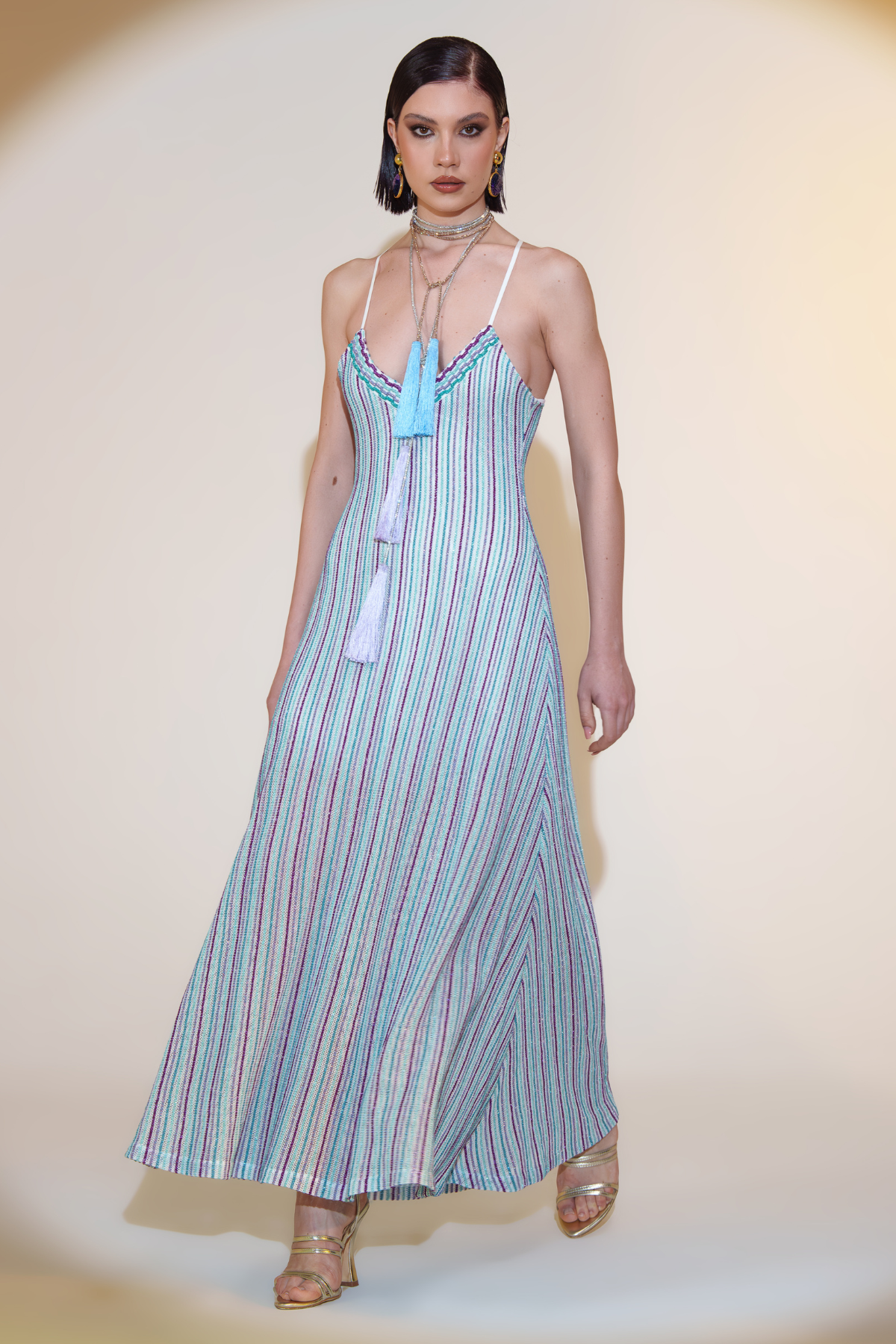 Modelo con vestido largo Pho Firenze Diana en color neutro posando sobre fondo blanco con diseño elegante y fluido para eventos especiales