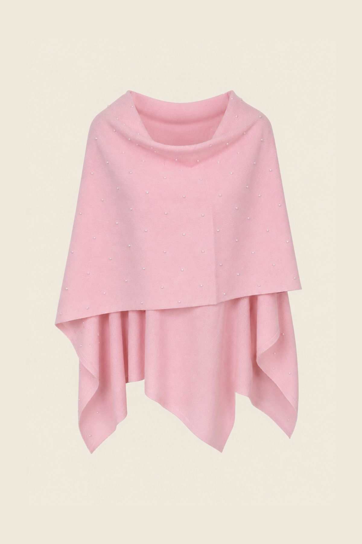 Poncho rosa sobre percha, tejido de cashmere y merino suave y caída fluida perfecta para estilismos de entretiempo