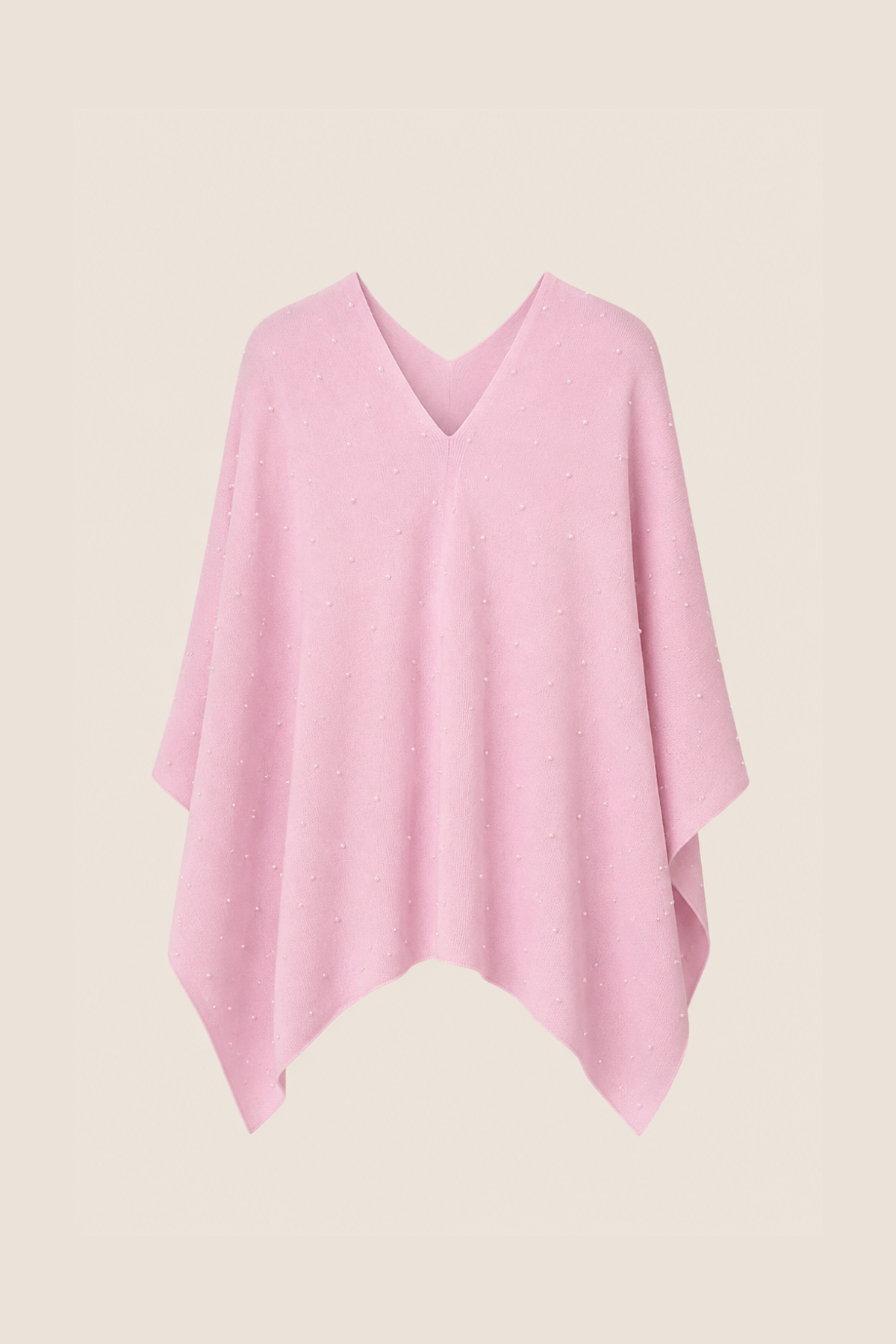 Poncho rosa sobre percha, tejido de cashmere y merino suave y caída fluida perfecta para estilismos de entretiempo