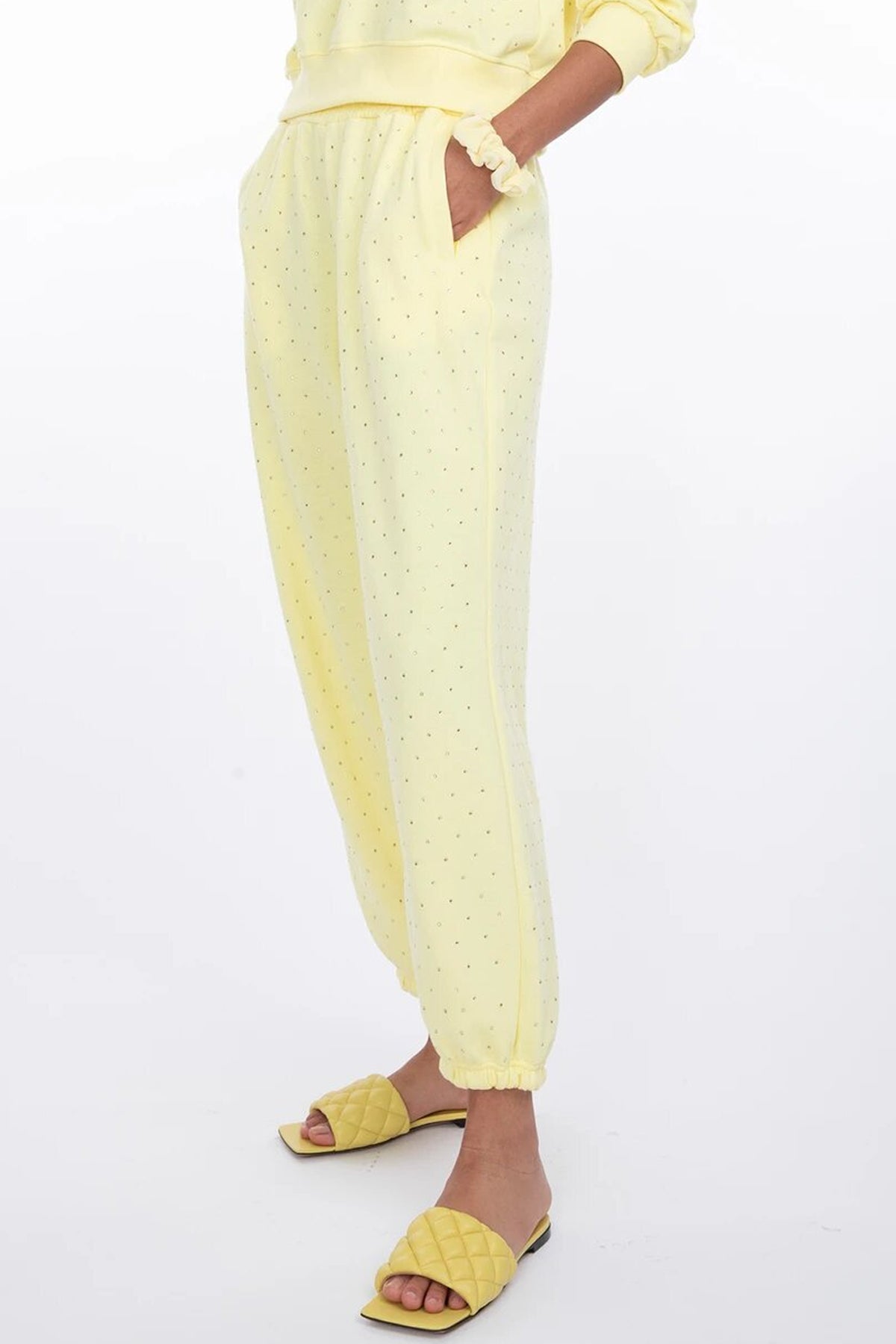 Vista lateral de la modelo con los Rena Crystal yellow, destacando el perfil de la cintura alta y la silueta favorecedora