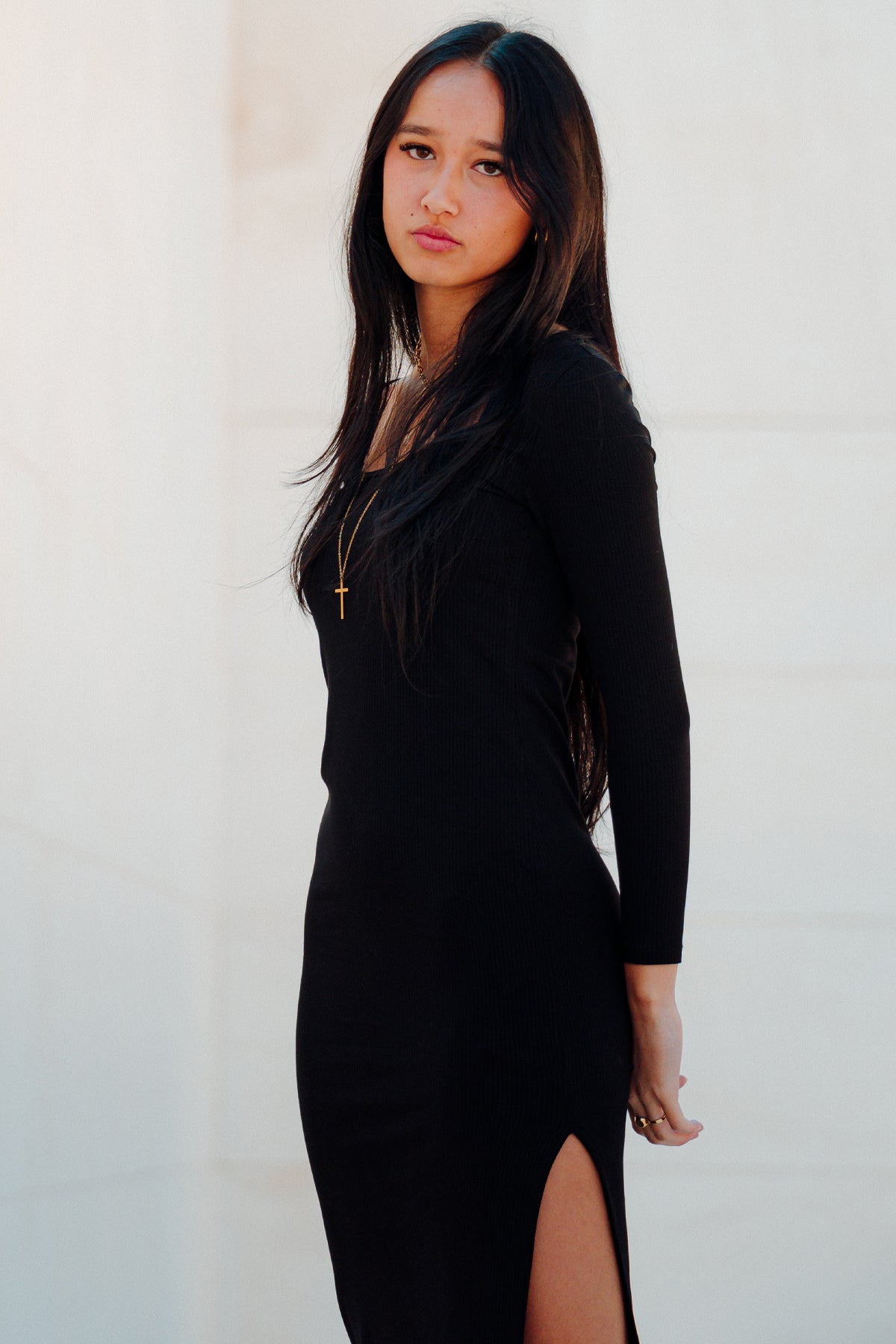 Modelo posando de perfil con vestido midi Vila Red Ribbed negro, mostrando su ajuste ceñido y textura de canalé