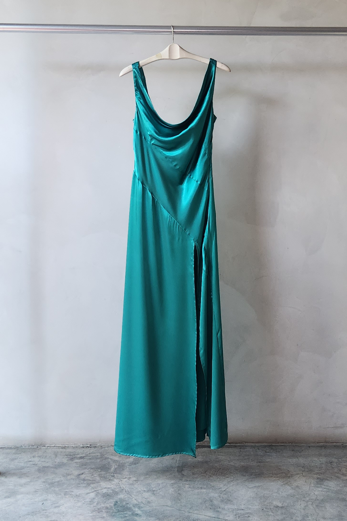 vestido Alfina largo en tono Smeraldo caída ligera, tirantes delicados en ambiente interior iluminado.