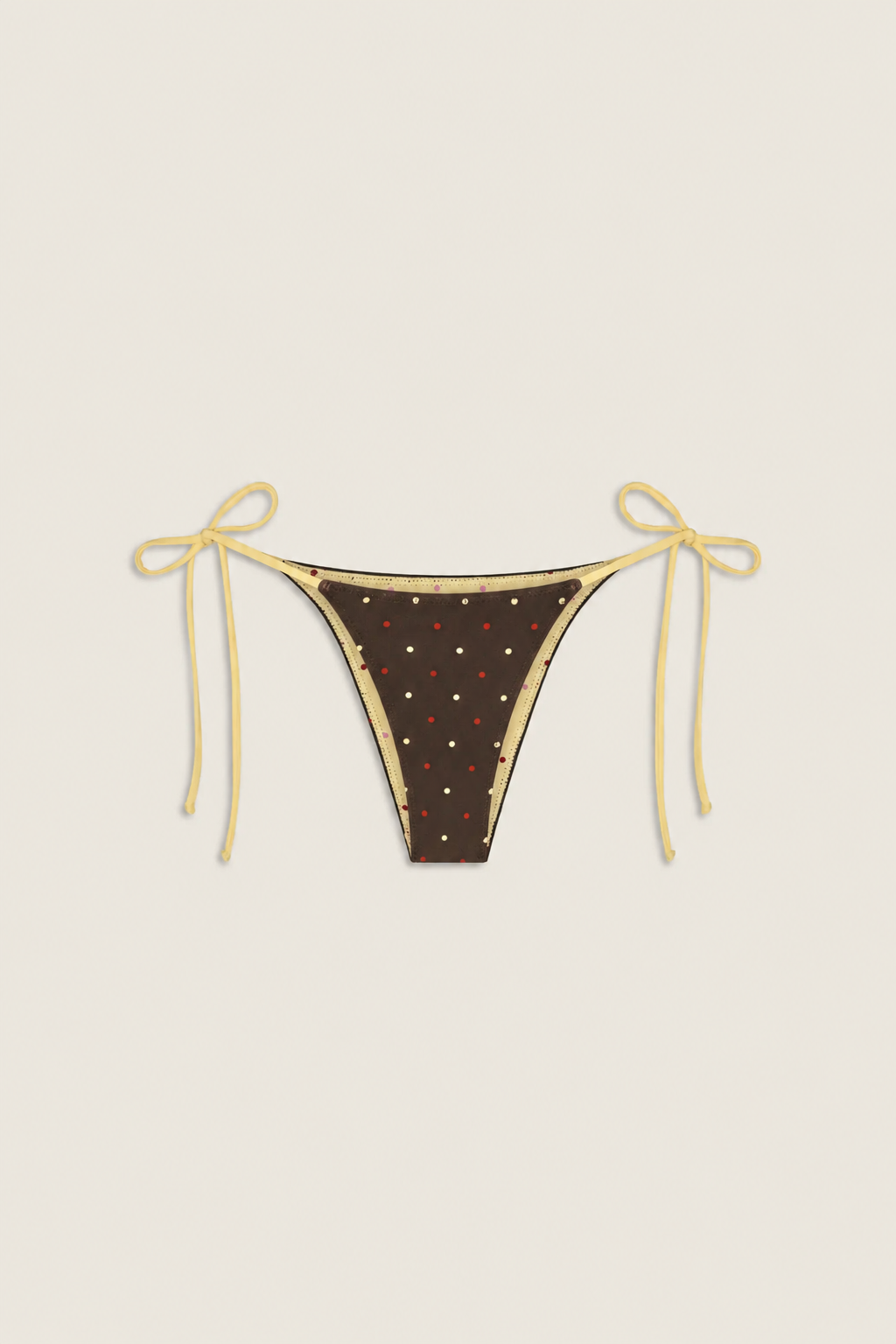 Vista de una braguita de bikini marrón con lunares rojos y tirantes amarillos para atar a los lados, que muestra el estampado divertido y el diseño limpio y minimalista.