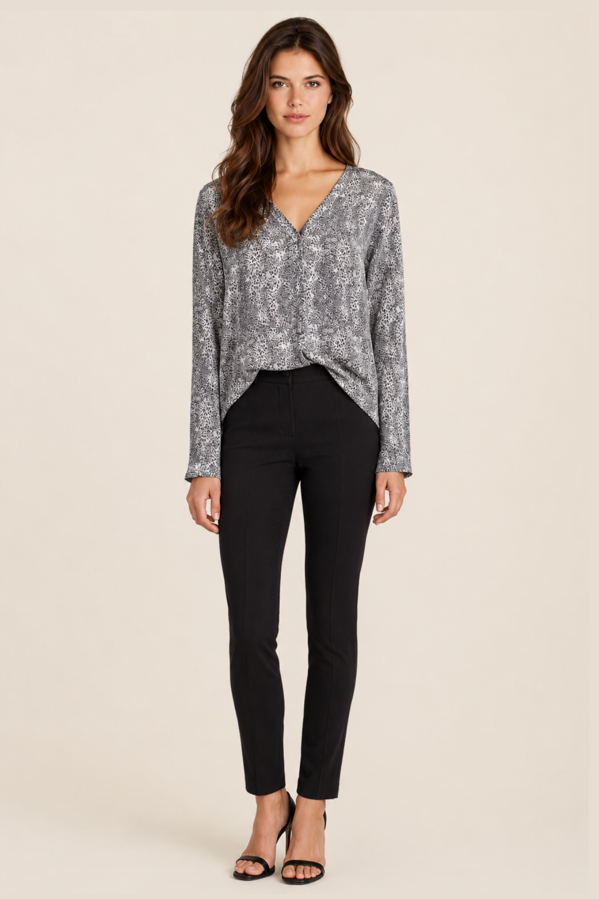 Modelo de frente con blusa Joie Michi en seda estampada cheetah negro, cuello en V y caída fluida ideal para looks sofisticados