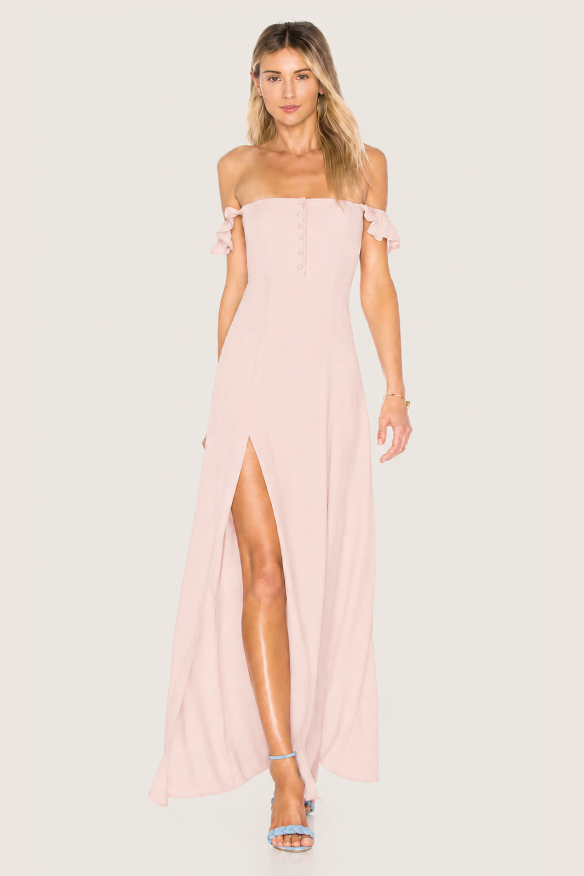 Modelo con vestido Bardot Sweet Cherry Pie rosa, escote recto y volantes Bardot sobre fondo blanco
