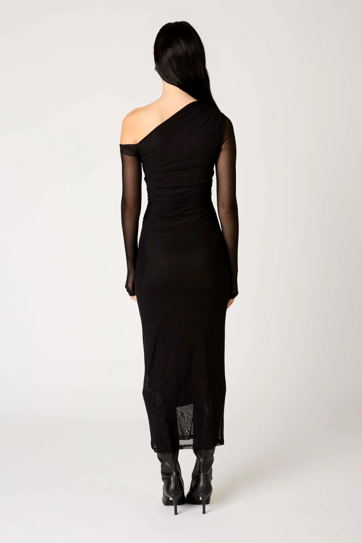 Vista trasera del vestido Lyra largo en color negro, mostrando la caída elegante del tejido y el corte estilizado para eventos formales