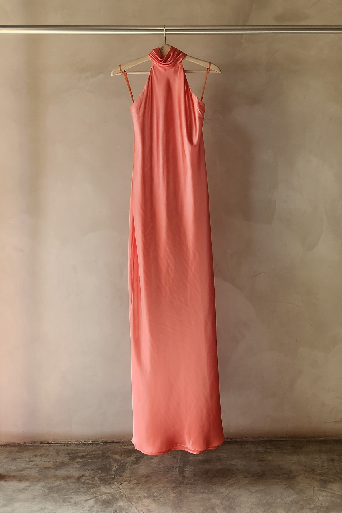 Maniquí con vestido Lana coral halter largo, tela vaporosa y silueta estilizada perfecta para eventos de verano y bodas al aire libre